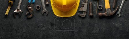 Photo for Worn and used work tools with a yellow construction hard hat. Home improvement, Father's day, or Labor day concept. - Royalty Free Image