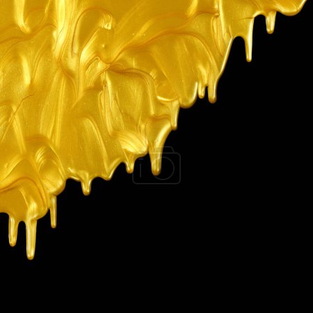 Photo for Glittering shiny metallic gold paint flowing and dripping downward. Isolated on black. - Royalty Free Image