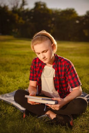 Foto de Adolescente estudiando en el parque, preparándose para los exámenes al aire libre, espacio para copiar - Imagen libre de derechos