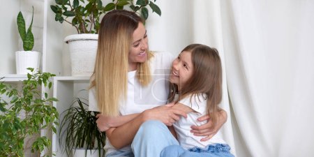 Photo for Mom and daughter happy at home. mother's day greeting and celebration - Royalty Free Image