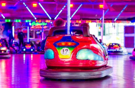Photo for People riding bumper cars at  at the fair. - Royalty Free Image