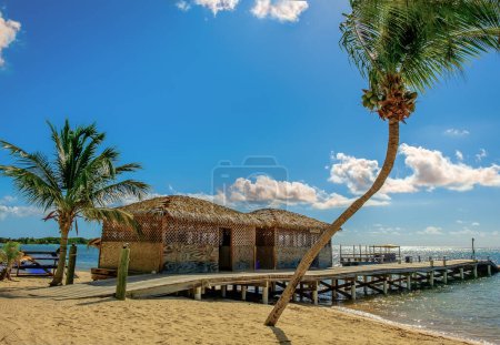 Two wooden huts and a pier by the Caribbean Sea on South Hole Sound, Little Cayman, Cayman Islands