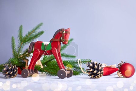 Photo for Christmas card with vintage wooden horse decoration for christmas tree and garland at old board. - Royalty Free Image