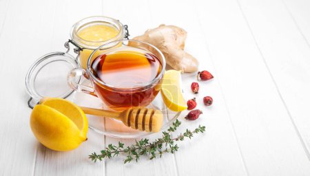 Photo for Ginger tea with lemon honey and thyme at white wooden board in r - Royalty Free Image