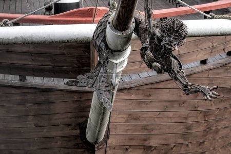 Photo for Metallic mermaid at the bow of a sailboat - Royalty Free Image
