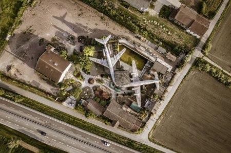 Photo for An impressive aerial shot of two abandoned airplanes, left to rust and decay, with a panoramic view of the surrounding area. - Royalty Free Image