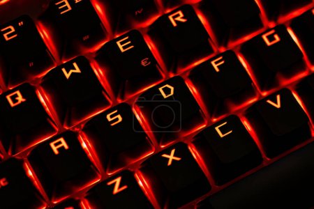 Photo for Close-up of a gaming keyboard with illuminated backlit keys, highlighting precision and design. - Royalty Free Image
