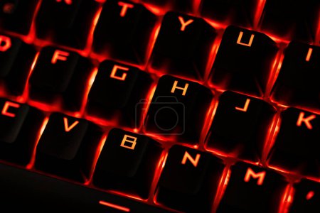 Photo for Close-up of a gaming keyboard with illuminated backlit keys, highlighting precision and design. - Royalty Free Image