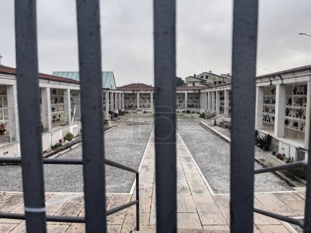 Photo for Glimpse of a cemetery through iron bars. - Royalty Free Image