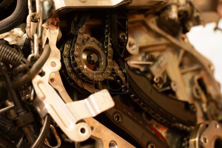 Detailed view of a car engine's timing chain with maintenance and replacement symbol.