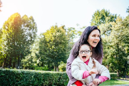 Photo for Woman and child enjoy walk autumn sunny day outside. Happy family moments concept. Lovely child in eyeglasses with cute facial expression. - Royalty Free Image