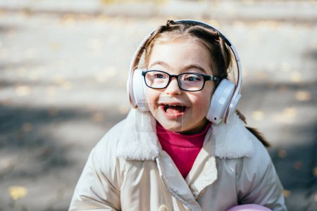Photo for Happy disability kid outdoor portrait. Special need child happy time to use headphones. - Royalty Free Image