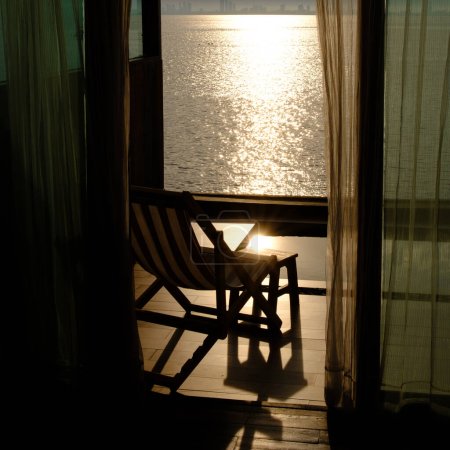 Photo for One beach chair in the room  with sea view - Royalty Free Image