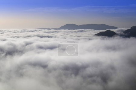 Photo for Photographic documentation of the moment when the fog rises in the valley early in the morning - Royalty Free Image