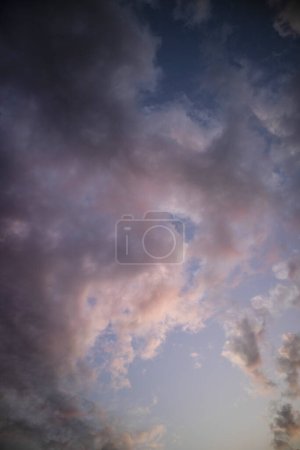 Photo for Photographic documentation of a group of colored clouds taken at sunset - Royalty Free Image