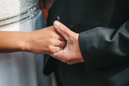 Photo for Close-up photo of the hands of the bride and groom, decorated with wedding rings. The beauty of their intertwined fingers. Rings on the hand of the bride and groom - Royalty Free Image