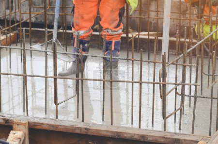 Concrete cast-in-place work. Builder level wet concrete. Concrete works on buildiiing construction site