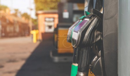 Photo for Close up of diesel and petrol fuel pistols at a gas station. The fuel crisis continues and the cost of fuel is going up - Royalty Free Image