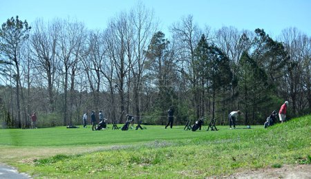 Téléchargez les photos : Les gens au terrain de golf driving range pratiquant frapper des balles de golf sur fairway à Winder, Géorgie,, États-Unis. - en image libre de droit