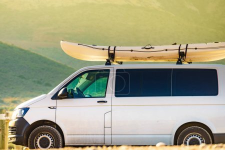 Photo for Car van with canoe on top roof against mountain nature. Active lifestyle sports concept. - Royalty Free Image