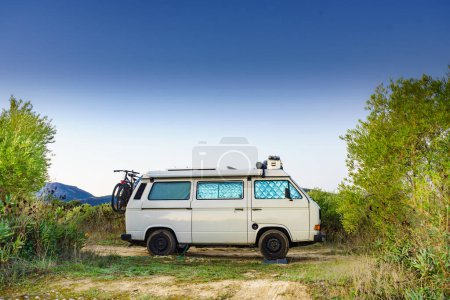 Photo for Camper van with internal thermal screen blind at window pane camping on nature in summer. Vanlife. Caravan vacation. - Royalty Free Image