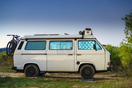 Photo for Camper van with internal thermal screen blind at window pane camping on nature in summer. Vanlife. Caravan vacation. - Royalty Free Image
