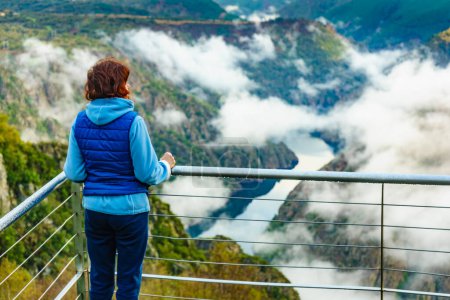 Photo for Tourist woman enjoying morning mountain view. River Sil Canyon in Parada de Sil, Galicia Spain. View from Cabezoa lookout. Relax on nature, mental freedom, stress heal. - Royalty Free Image