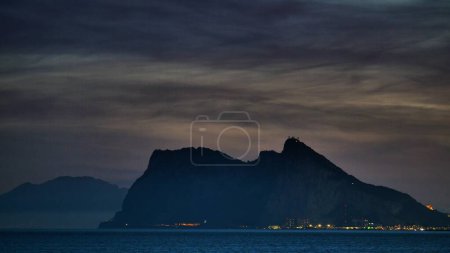 Gibraltar rock at night. View from Torrecarbonera beach, Punta Mala, Andalusia Spain. Tourist attraction.