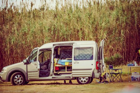 Van with camping equipment on nature. Vanlife.