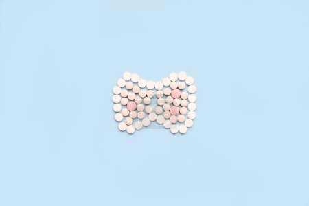 Photo for Thyroid gland made of pills. A symbol of protection and prevention from thyroid diseases - Royalty Free Image