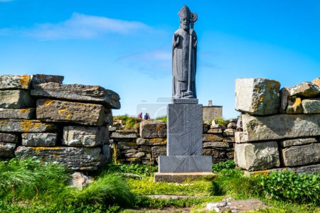 Photo for BALLYCASTLE,COUNTY MAYO, REPUBLIC OF IRELAND - JULY 15 2022 : Saint Patrick statue is standing at Downpatrick head not far from the sea stack. - Royalty Free Image