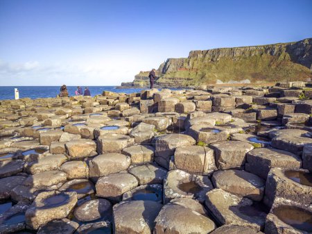 Photo for GIANTS CAUSEWAY, NORTHERN IRELAND, UK - NOVEMBER 05 2022 : People enjoying the 40000 interlocking basalt columns. - Royalty Free Image