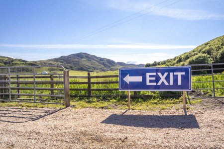 Photo for Exit sign on wooden fence of a farm and camping site. - Royalty Free Image