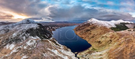 Photo for Aerial view of Altan Lough next to the the snow covered Mount Errigal, the highest mountain in Donegal - Ireland - Royalty Free Image