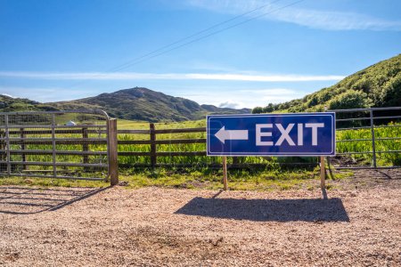 Photo for Exit sign on wooden fence of a farm and camping site. - Royalty Free Image