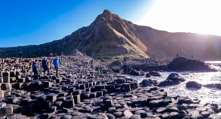 Photo for GIANTS CAUSEWAY, NORTHERN IRELAND, UK - NOVEMBER 05 2022 : People enjoying the 40000 interlocking basalt columns. - Royalty Free Image