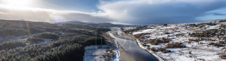 Téléchargez les photos : Aerial view of snow covered Gweebarra River between Doochary and Lettermacaward in Donegal - Ireland - The site of the new Cloughercor wind farm in the background. - en image libre de droit