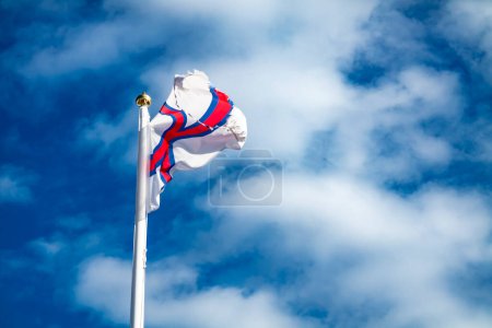 Photo for Flag of Faroe islands waving in the wind. - Royalty Free Image