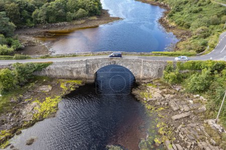 Photo for Aerial view of the bridge over Lackagh river close to Doe Castle by Creeslough in County Donegal, Republic of Ireland. - Royalty Free Image