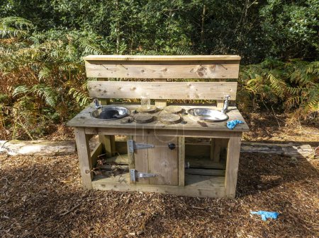 Children outdoor mud kitchen in a forest in County Donegal - Ireland.