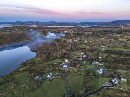 Photo for Smoke over Lough Fad due to traditionally burning of waste in rural Ireland - County Donegal. - Royalty Free Image