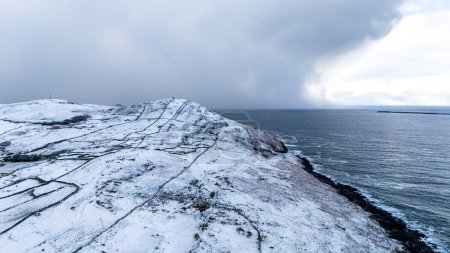 Photo for Aerial view of snow covered Dunmore Head, Bunaninver and Lackagh by Portnoo in County Donegal, Ireland - Royalty Free Image