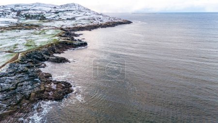 Aerial view of snow covered Dunmore Head, Bunaninver and Lackagh by Portnoo in County Donegal, Ireland