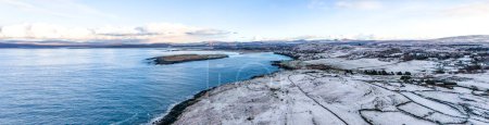 Aerial view of snow covered Inishkeel island by Portnoo in County Donegal, Ireland