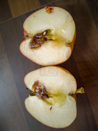 Sliced rotten apple on kitchen worktop.
