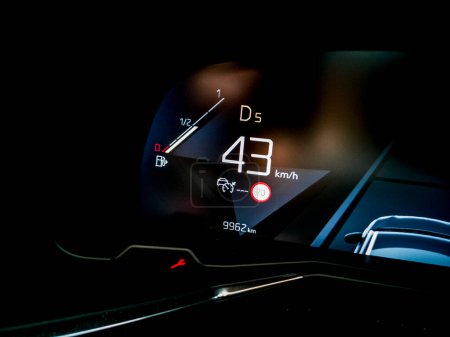 Modern fuel gauge in car dashboard.