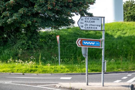Photo for KILLYBEGS, IRELAND - MAY 16 2023: The sign at the roundabout is showing the way to Kilcar and Carrick. - Royalty Free Image