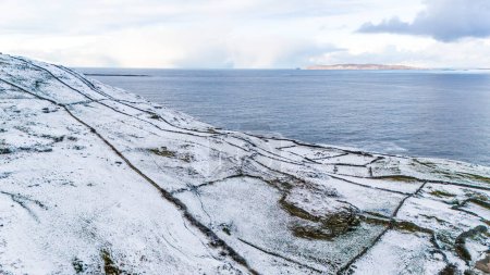 Photo for Aerial view of snow covered Dunmore Head, Bunaninver and Lackagh by Portnoo in County Donegal, Ireland - Royalty Free Image