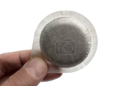 Photo for Close-up person holding coffee pod on white background - Royalty Free Image