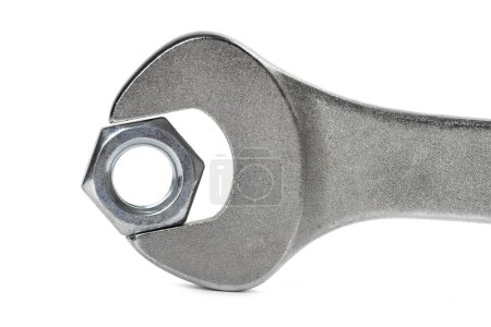 Photo for Close-up steel screw nut clamped in a wrench on white background - Royalty Free Image